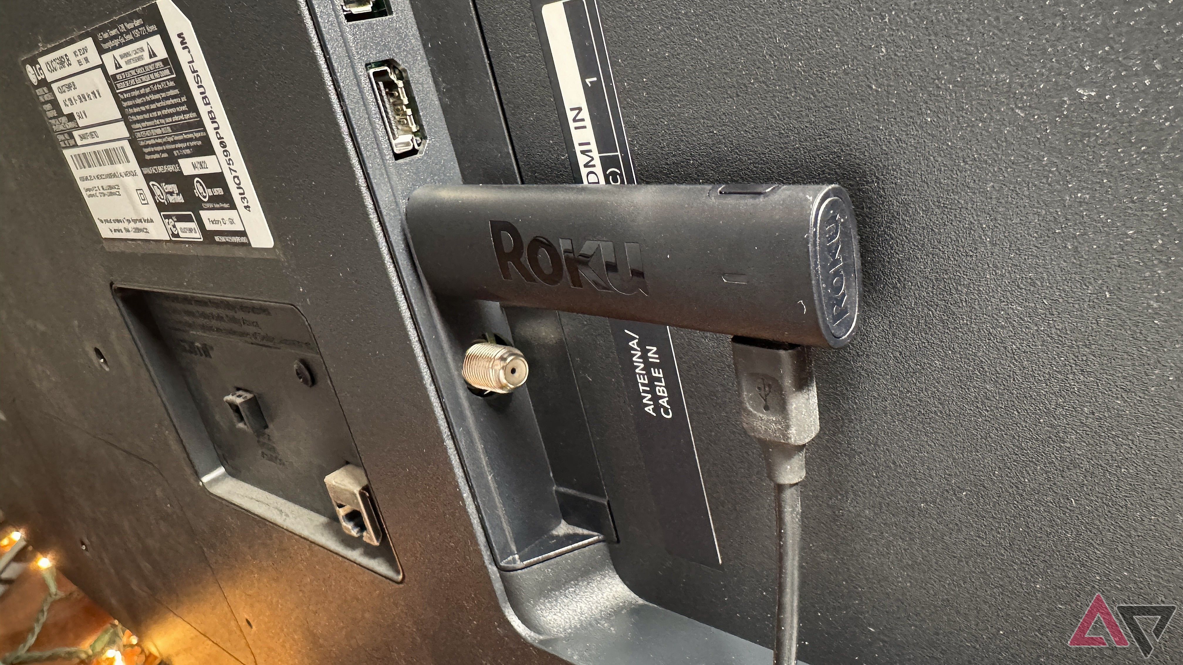 Roku Streaming Stick 4K in black plugged into an HDMI port in the back of a TV