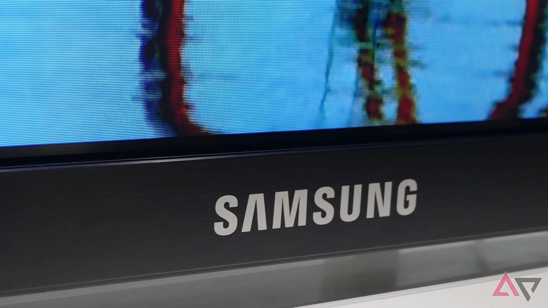 The Samsung logo on the bottom of a television.