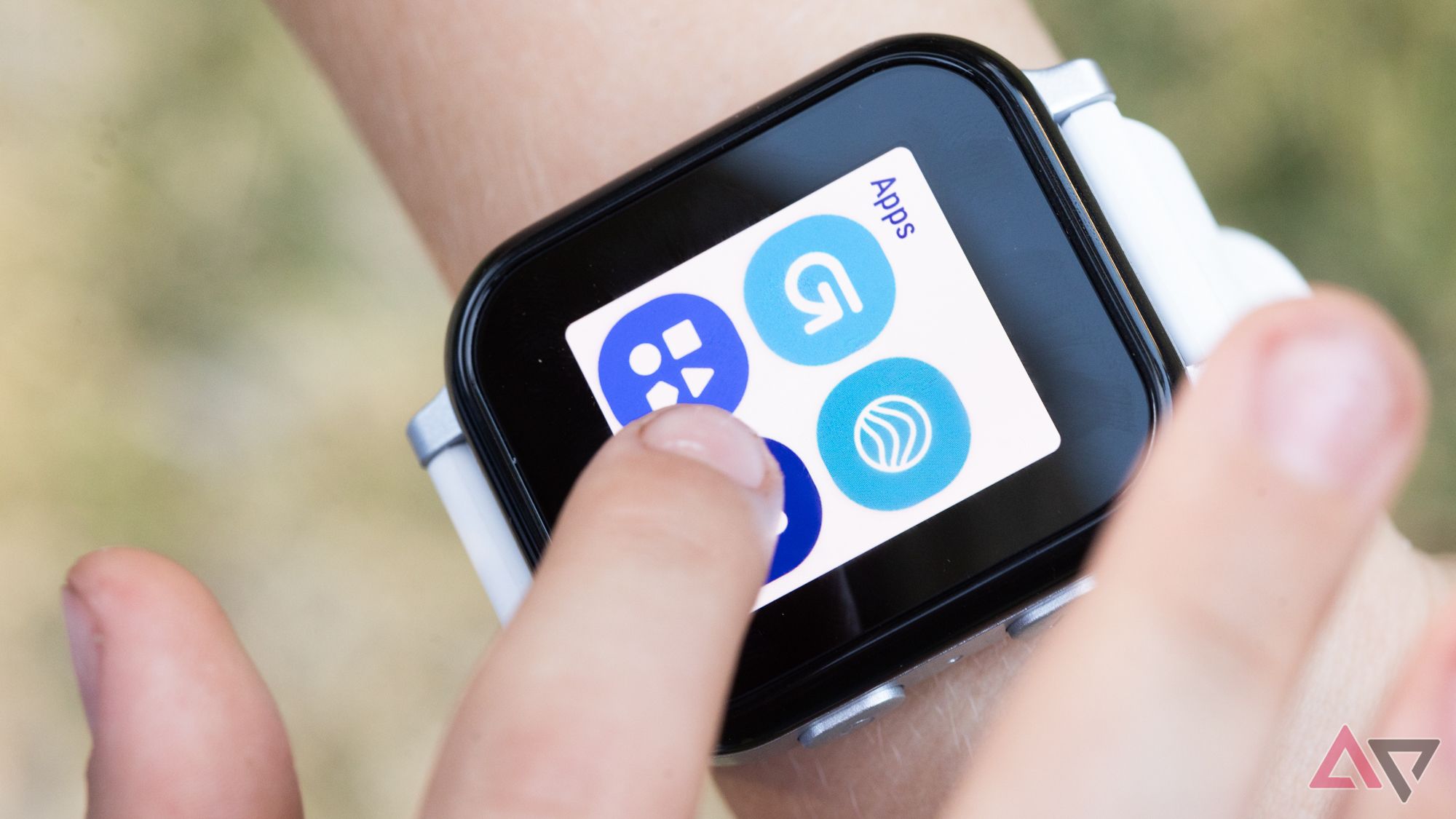 A finger selecting apps on a smartwatch