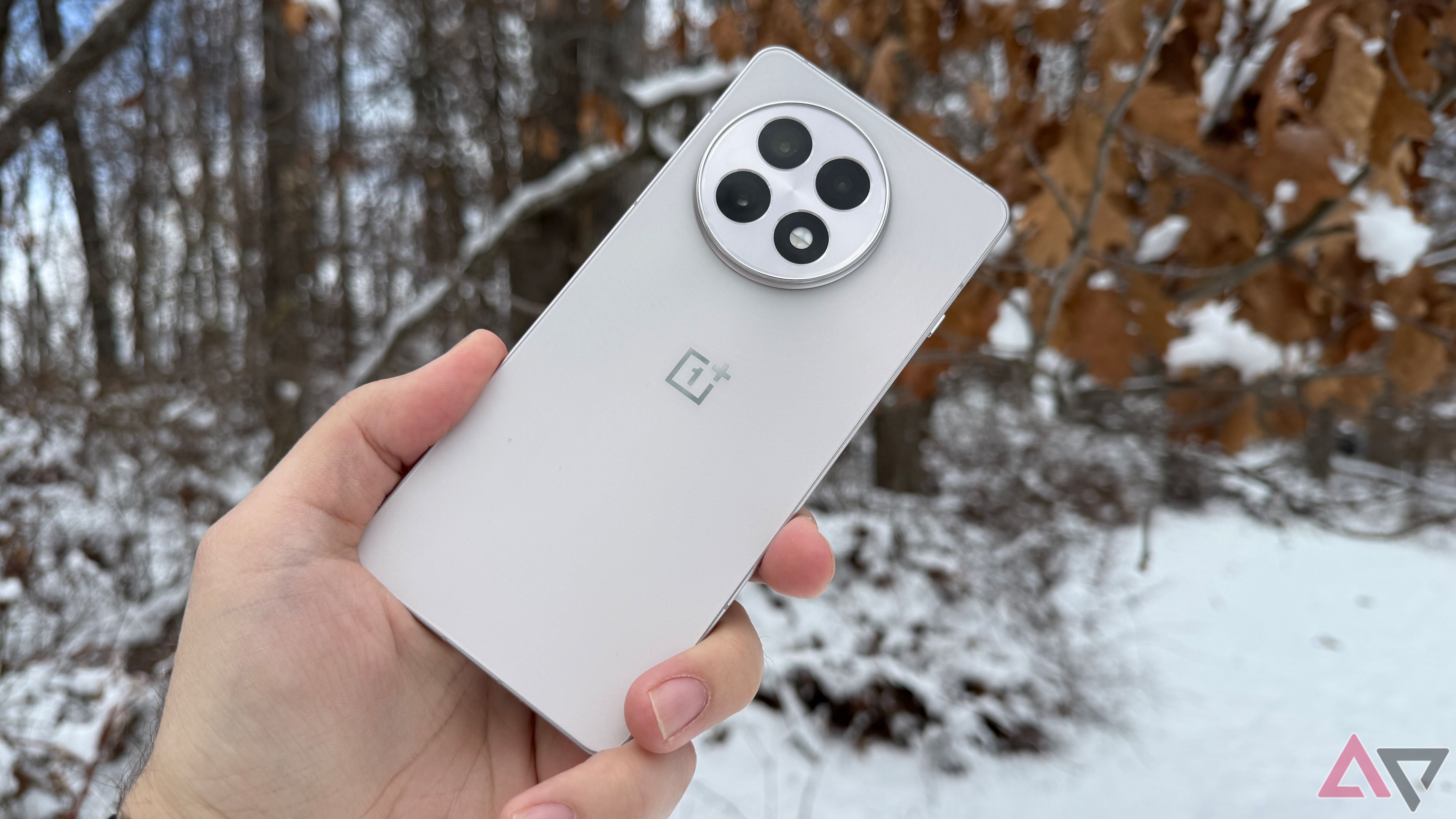 OnePlus 13R held against the snow