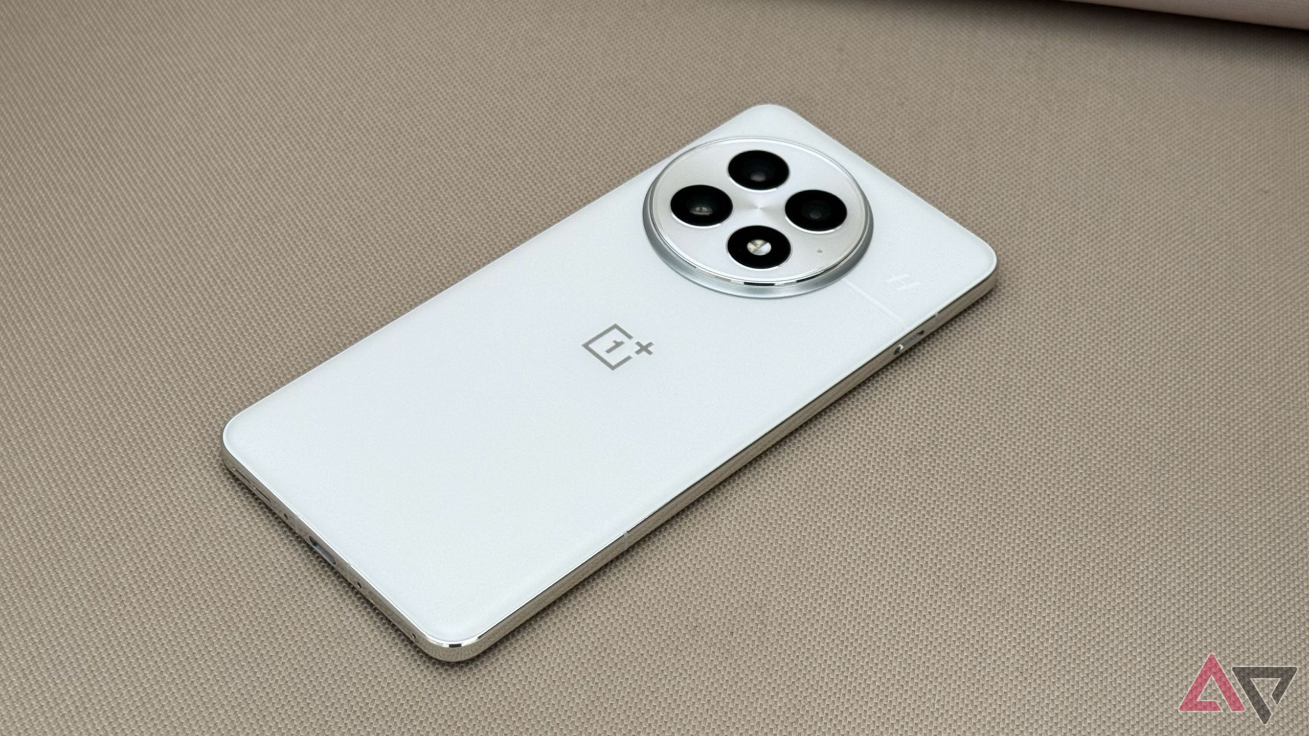 OnePlus 13 in white with circular camera module on table