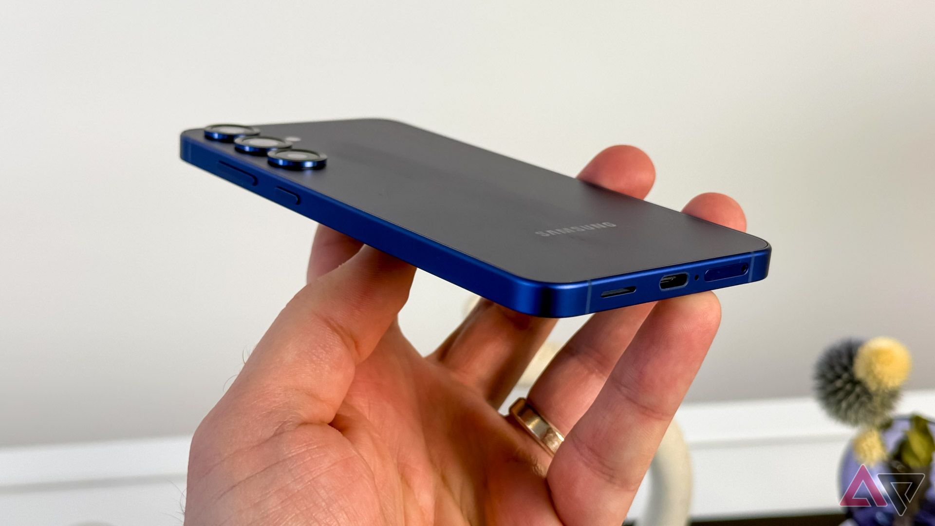 The Samsung Galaxy S25 in someone's hand showing the rear of the phone