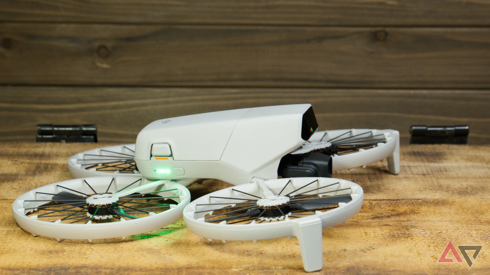 Right side of the DJI Flip showing the power button and lit up battery indicator LEDs