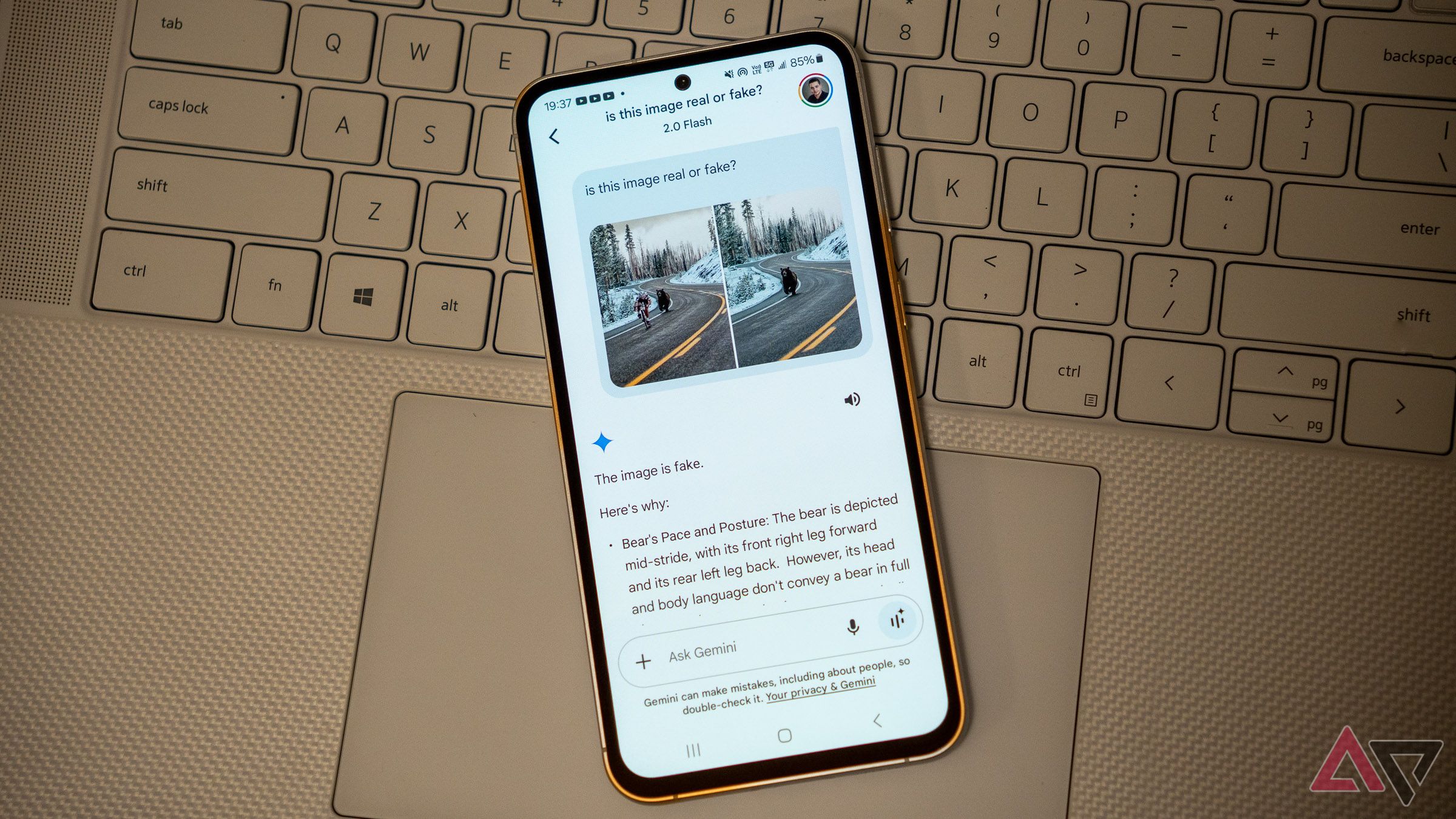 a samsung galaxy phone on a laptop keyboard with google gemini app opened