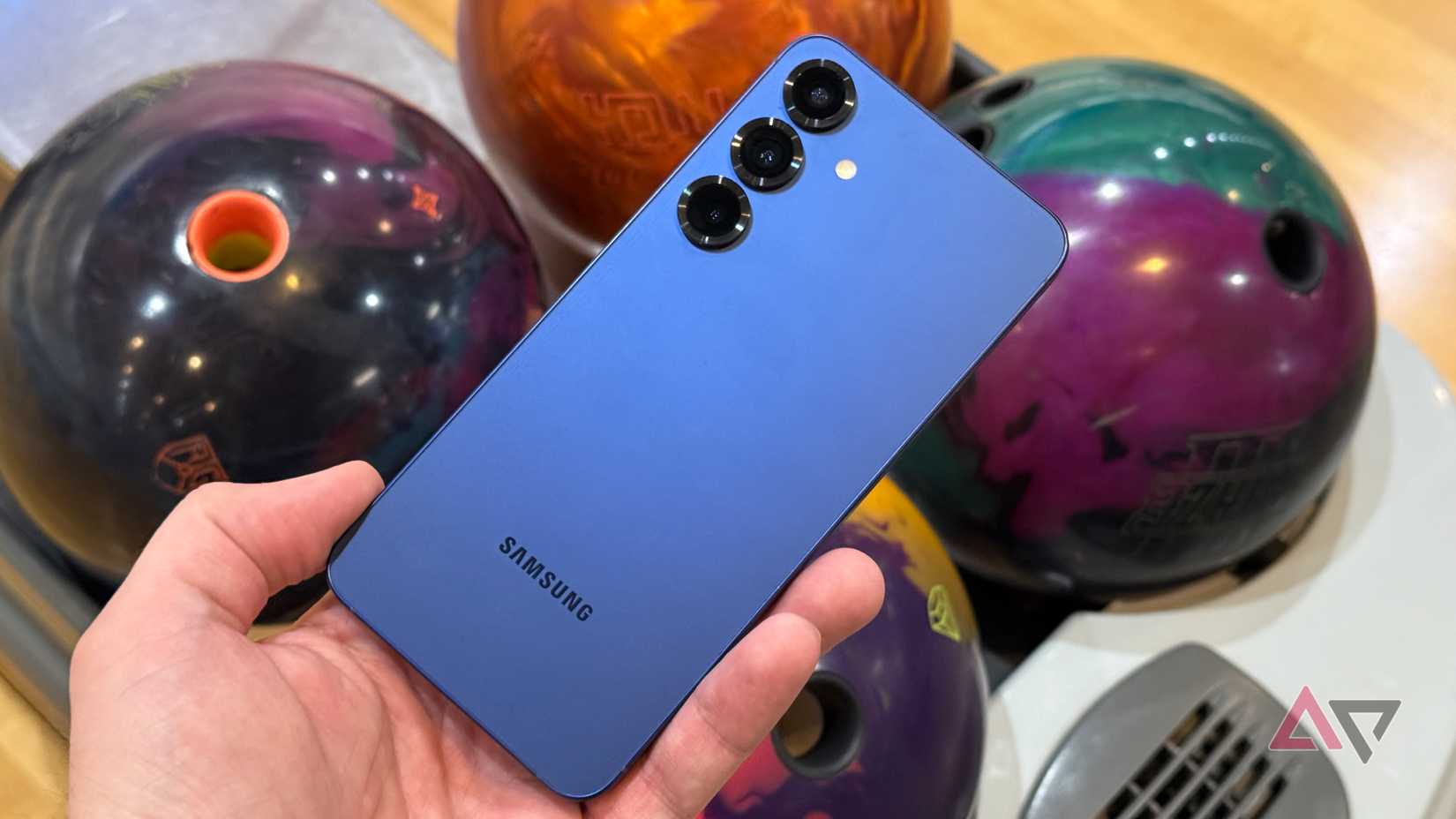 Samsung Galaxy S25+ held up against bowling balls