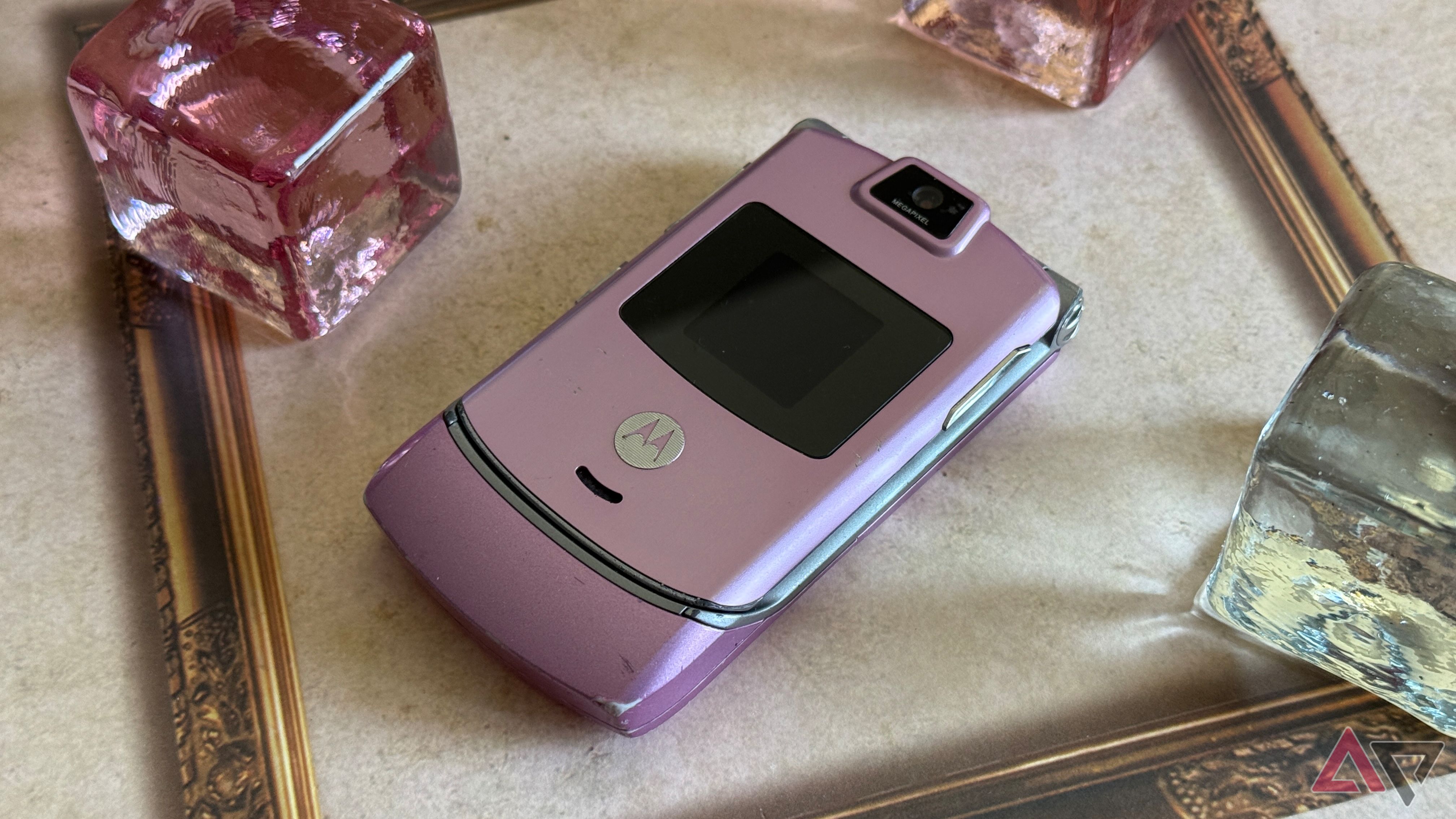 Motorola Razr V3 sitting on a desk in pink