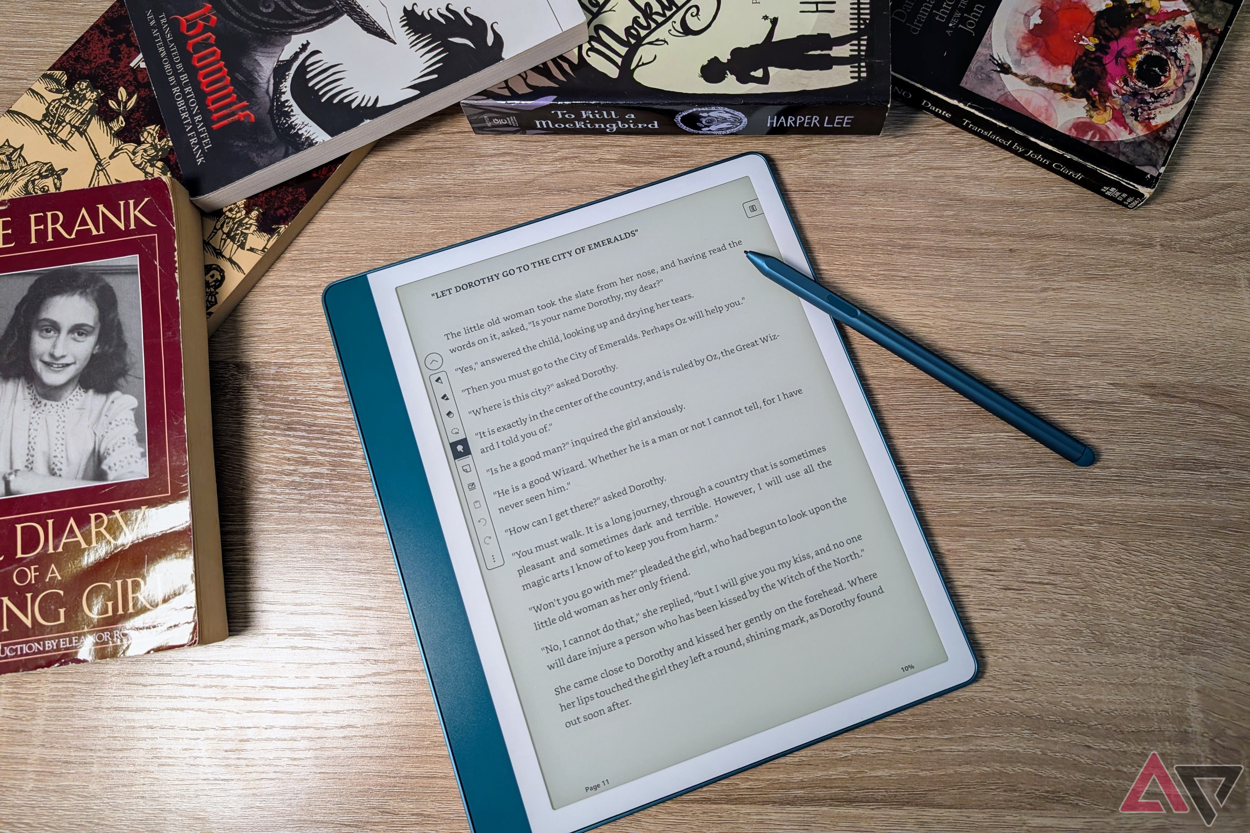 Kindle Scribe (2024) open to Wizard of Oz with pen surrounded by books
