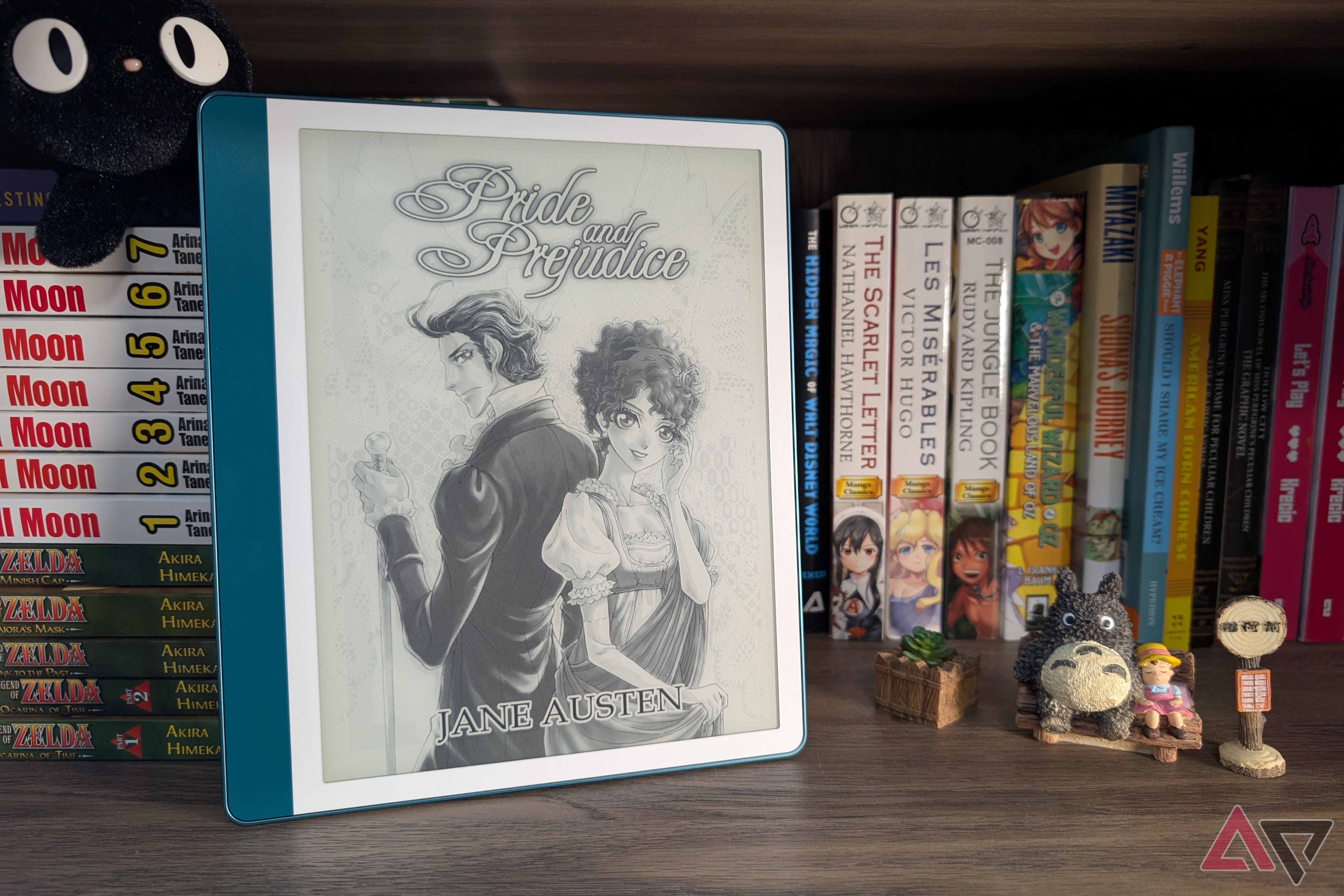Kindle Scribe (2024) on bookshelf with figurines