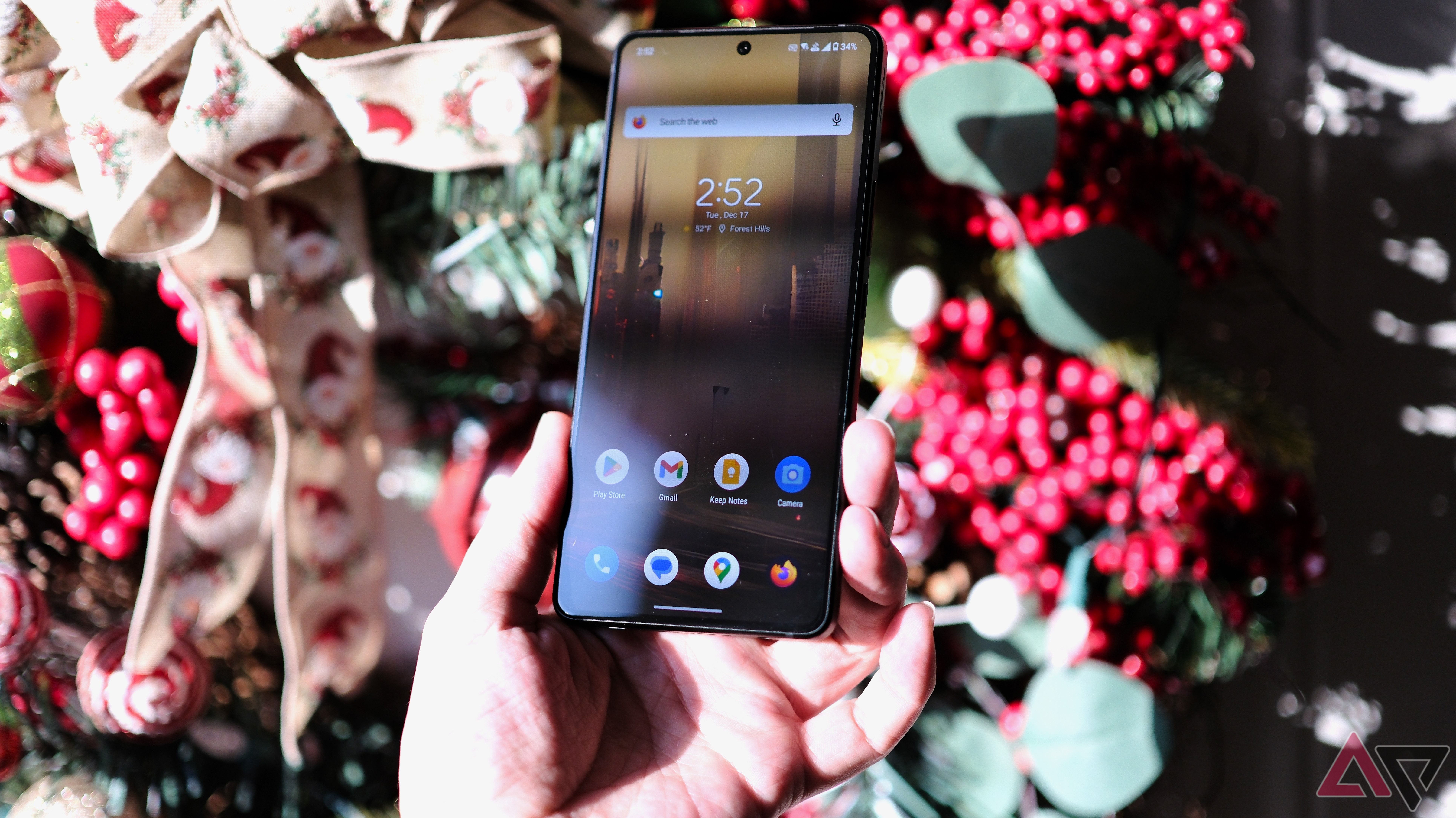 ROG Phone 9 Pro photo held in hand in front of wreath