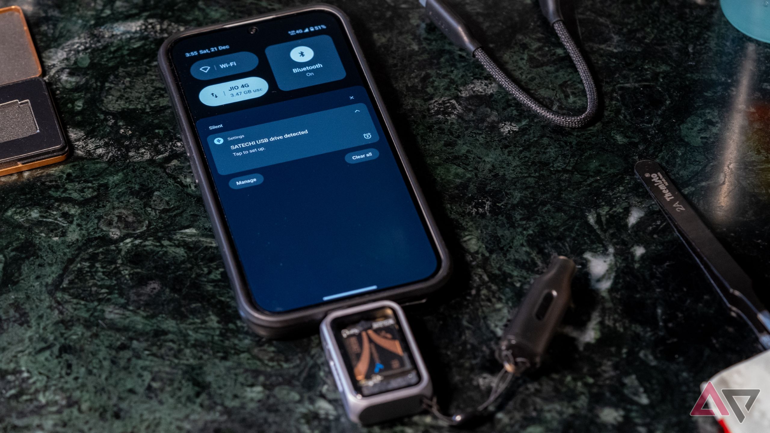 The Satechi SSD Enclosure plugged into an Android phone on a green marble table