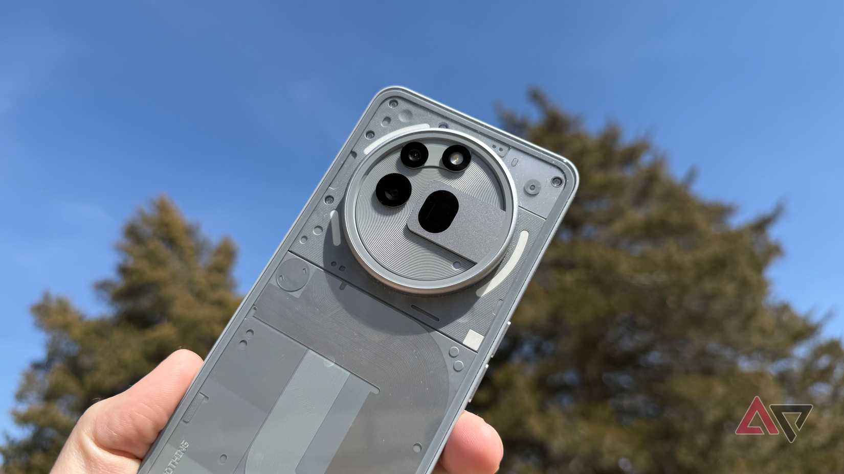 Nothing Phone 3a Pro in gray against a blue sky