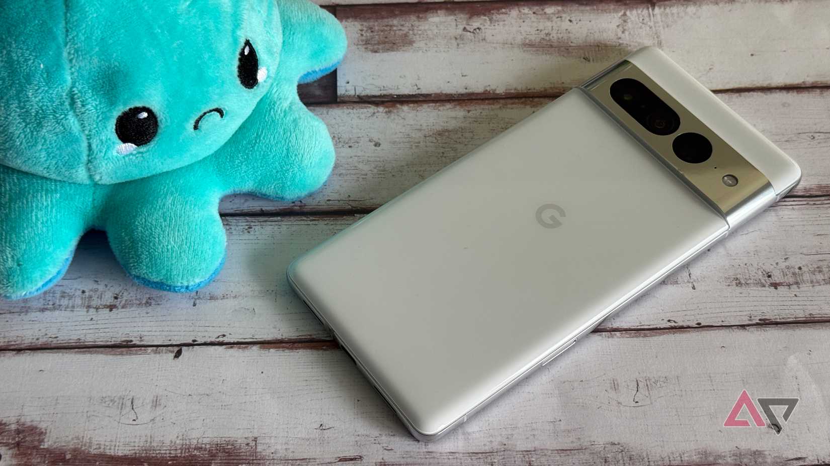 Google Pixel 7 Pro next to a blue frowning plushie
