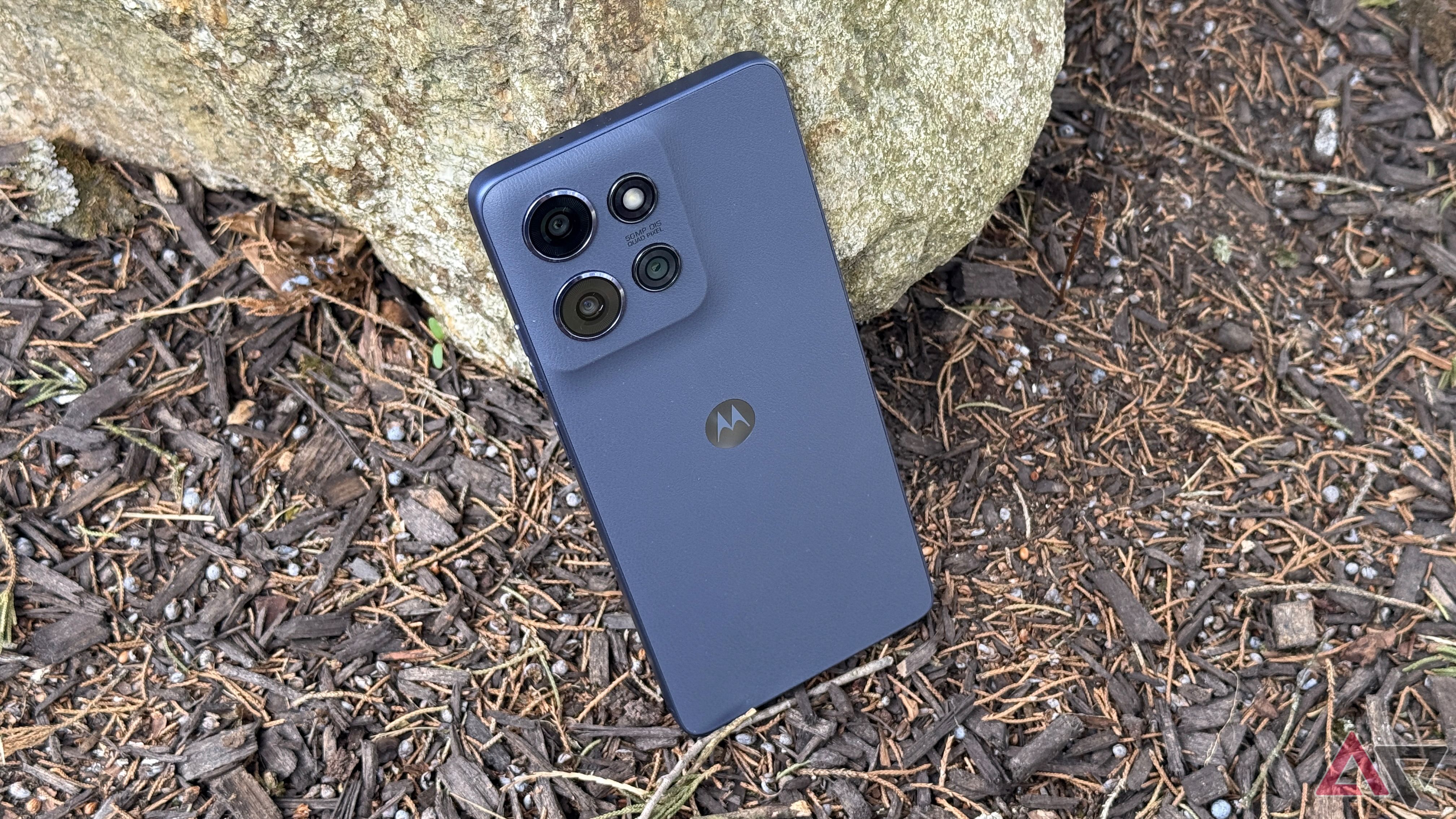 Moto G Power in Slate Gray standing against a rock