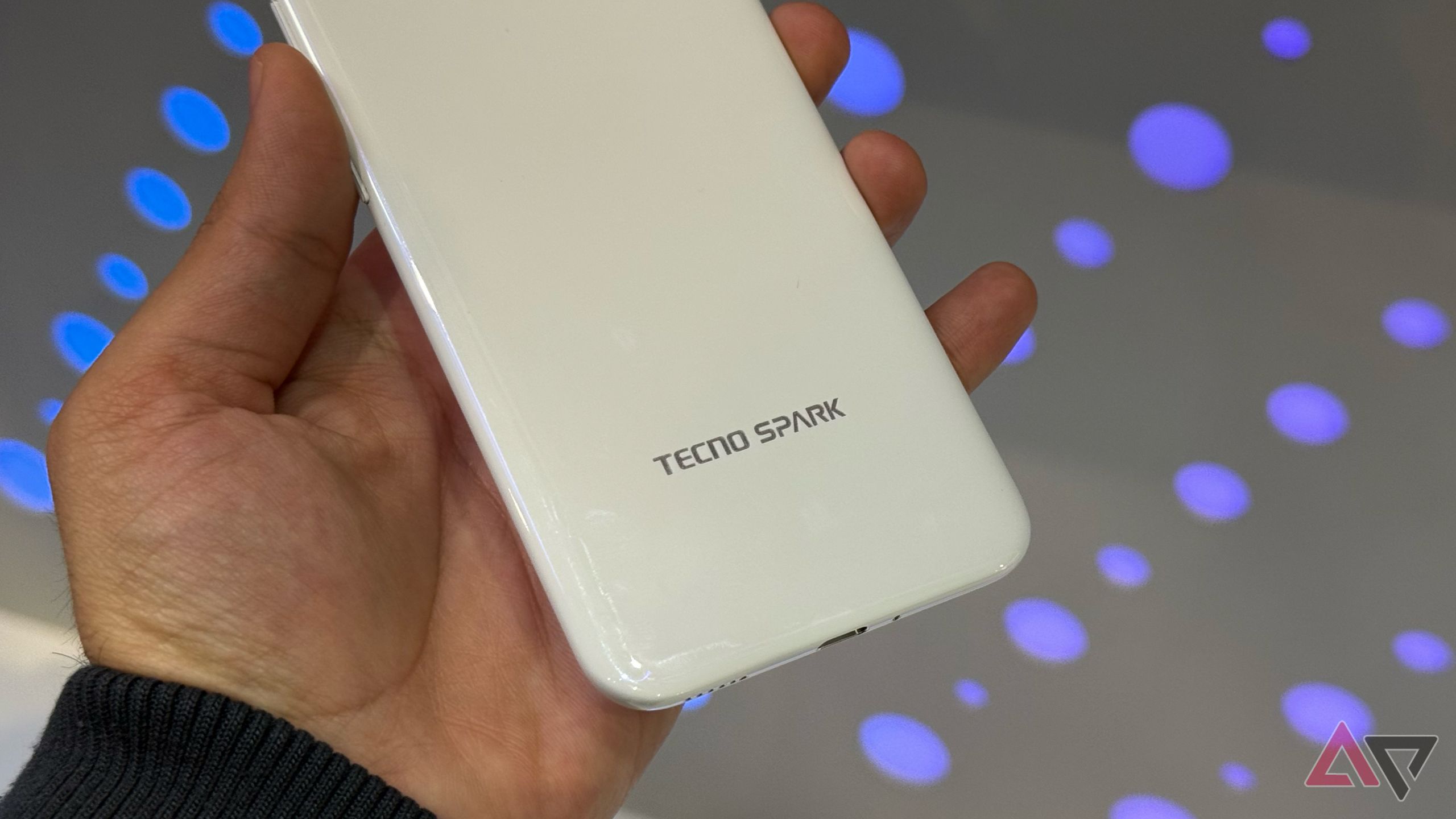 Tecno Spark Slim in hand showing the logo