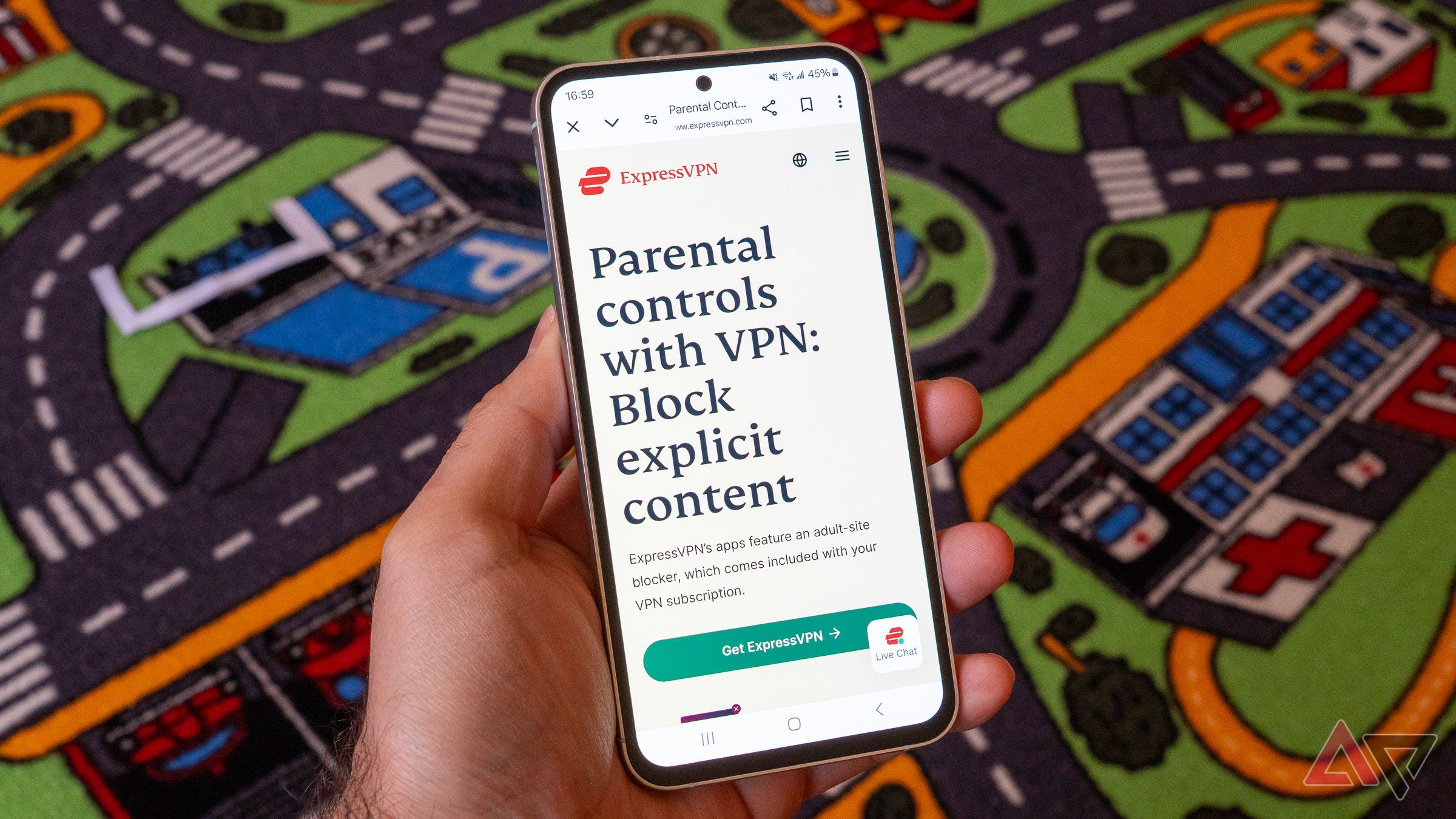 a phone in and displaying the website of expressvpn and a colorful carpet in the background 