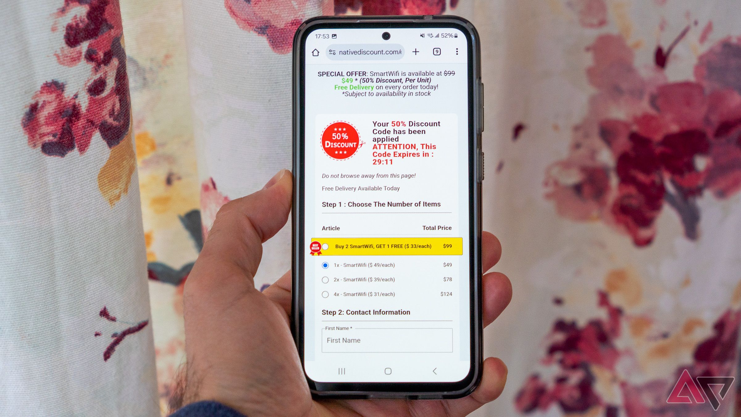 a phone in hand displaying a shopping site against a curtain in the background