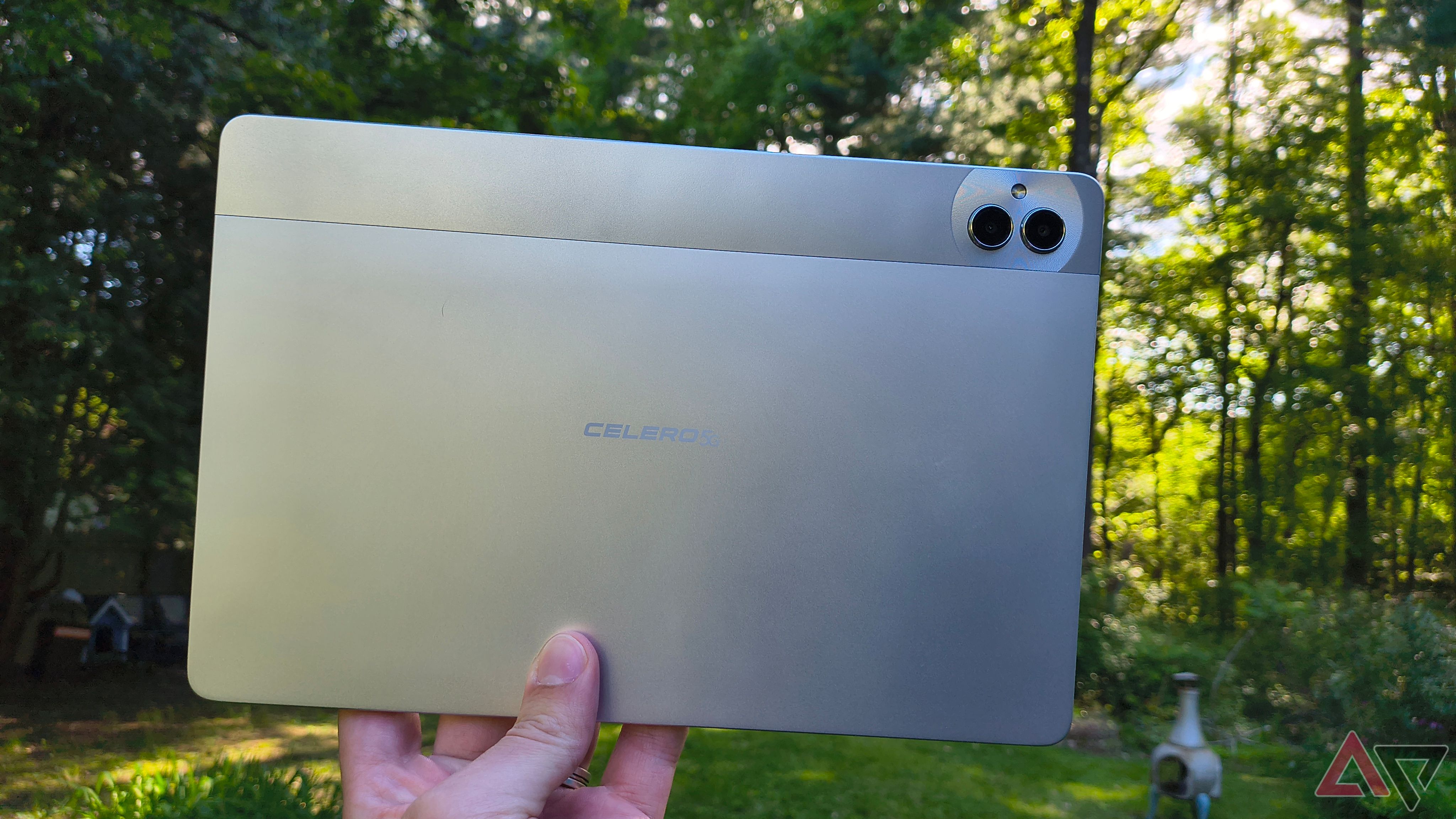 A Boost Celero5G TAB being held by someone outside with the back of the tablet visible