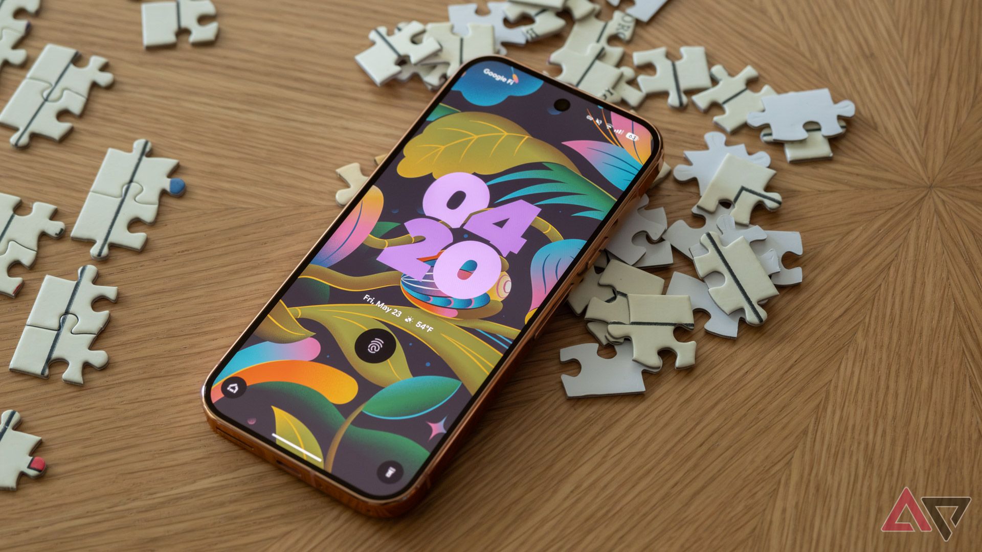 A Pixel 9 Pro sitting face-up on top of puzzle pieces.