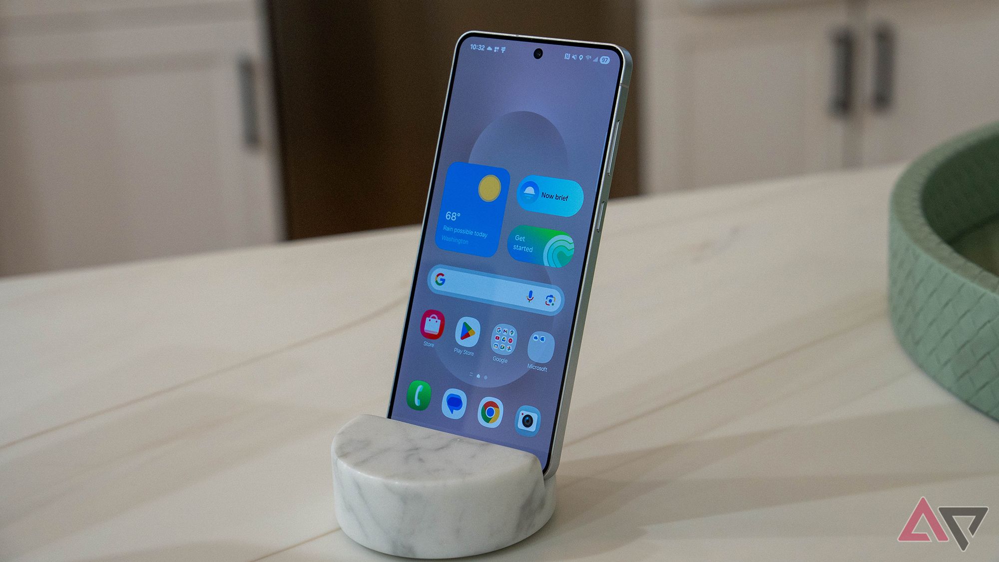 Modern smartphone in charging dock displaying weather and apps
