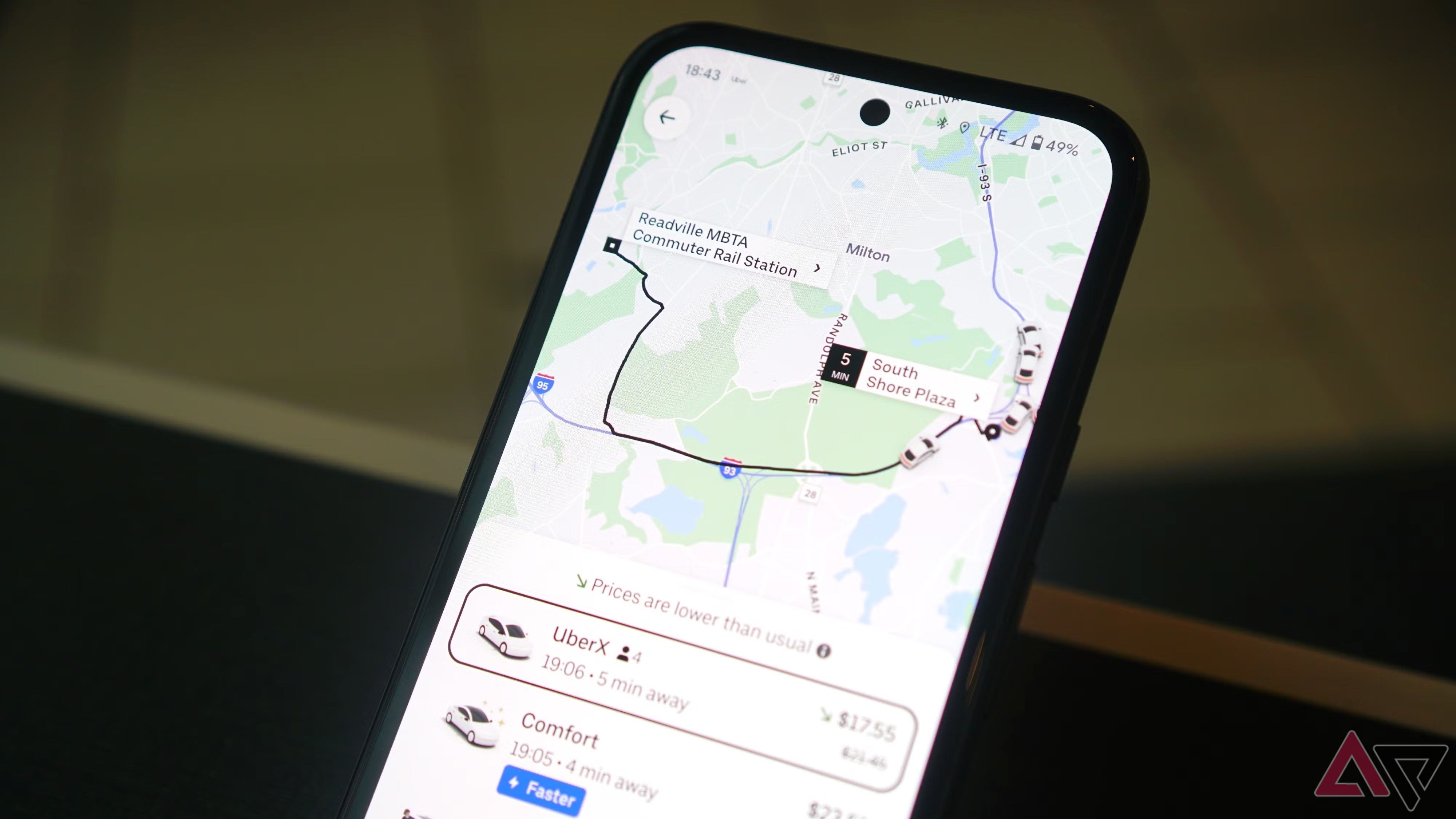A phone with the Uber app open, ready to request a ride from available drivers.