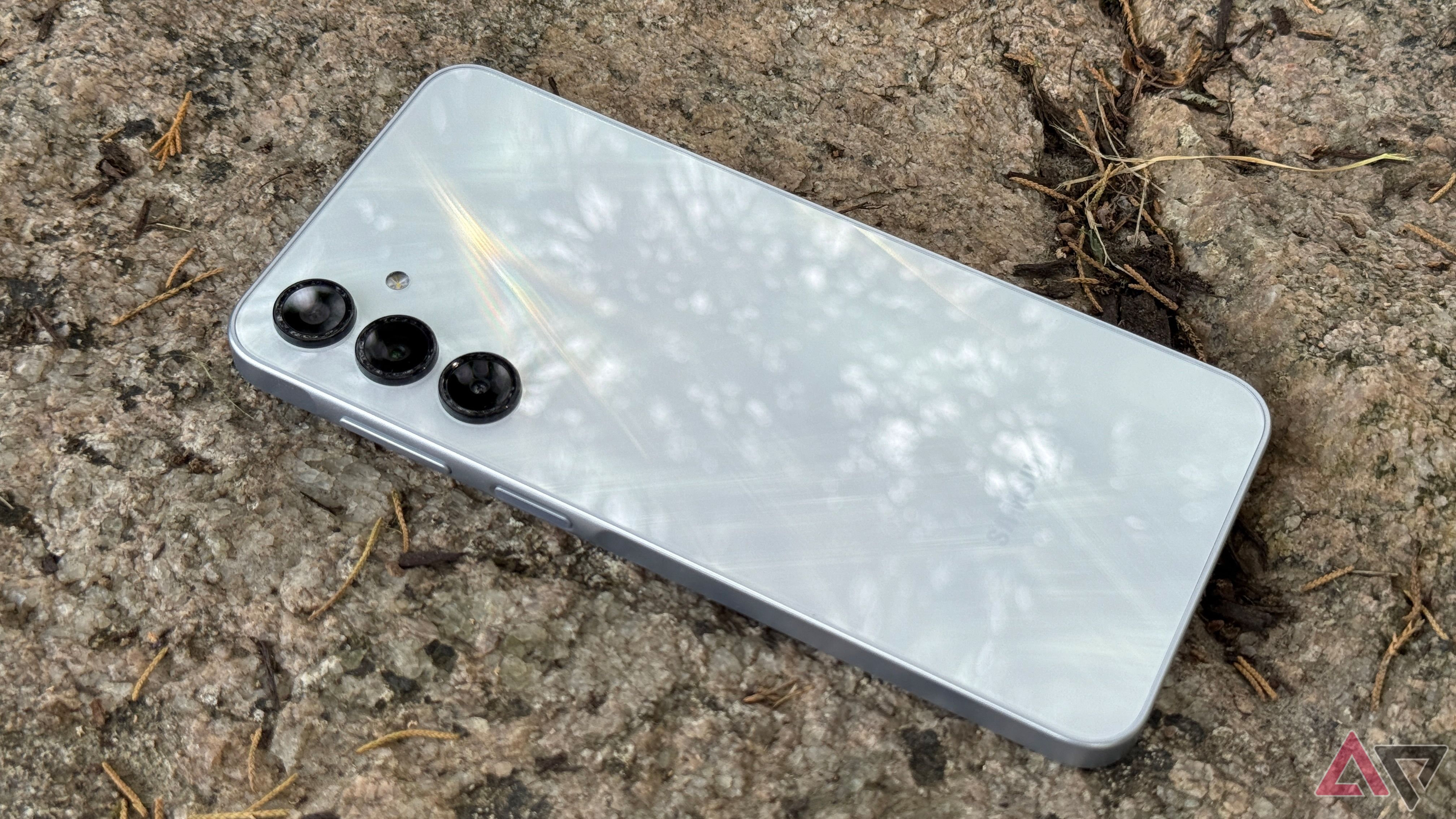 Samsung Galaxy A16 laying face down against a rock