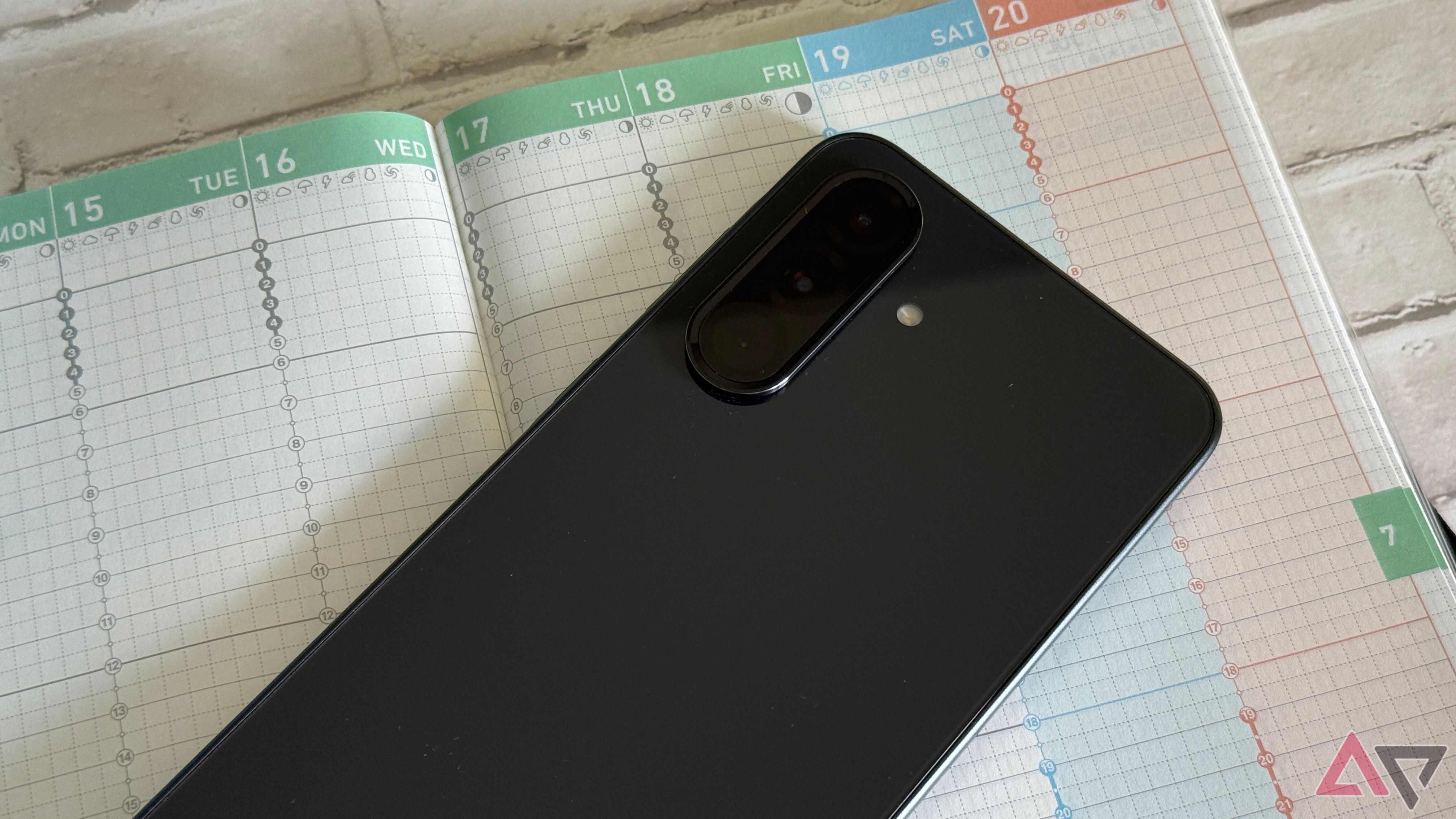 Samsung Galaxy A36 resting against a day planner