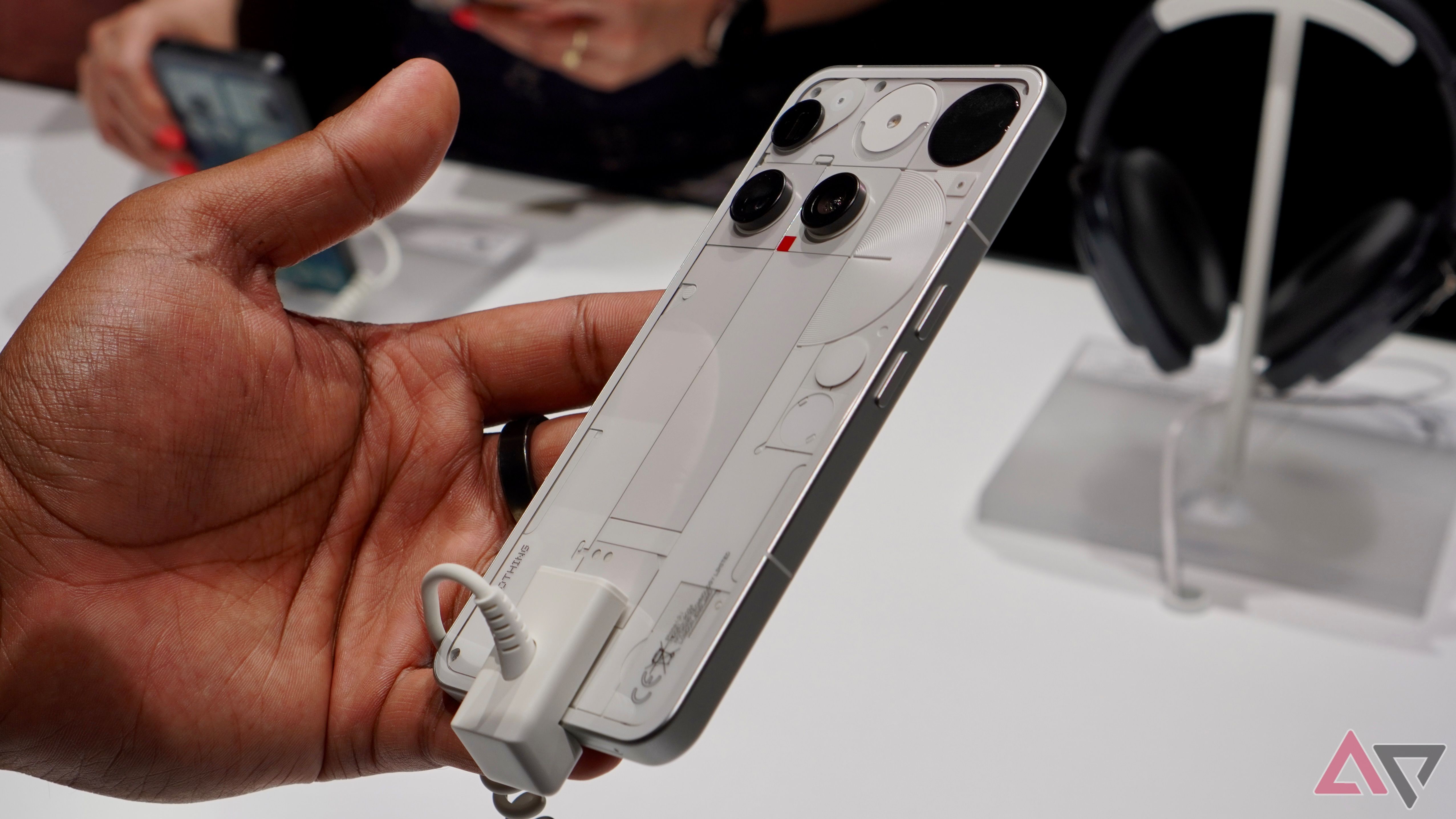 A person holding the white Nothing Phone 3