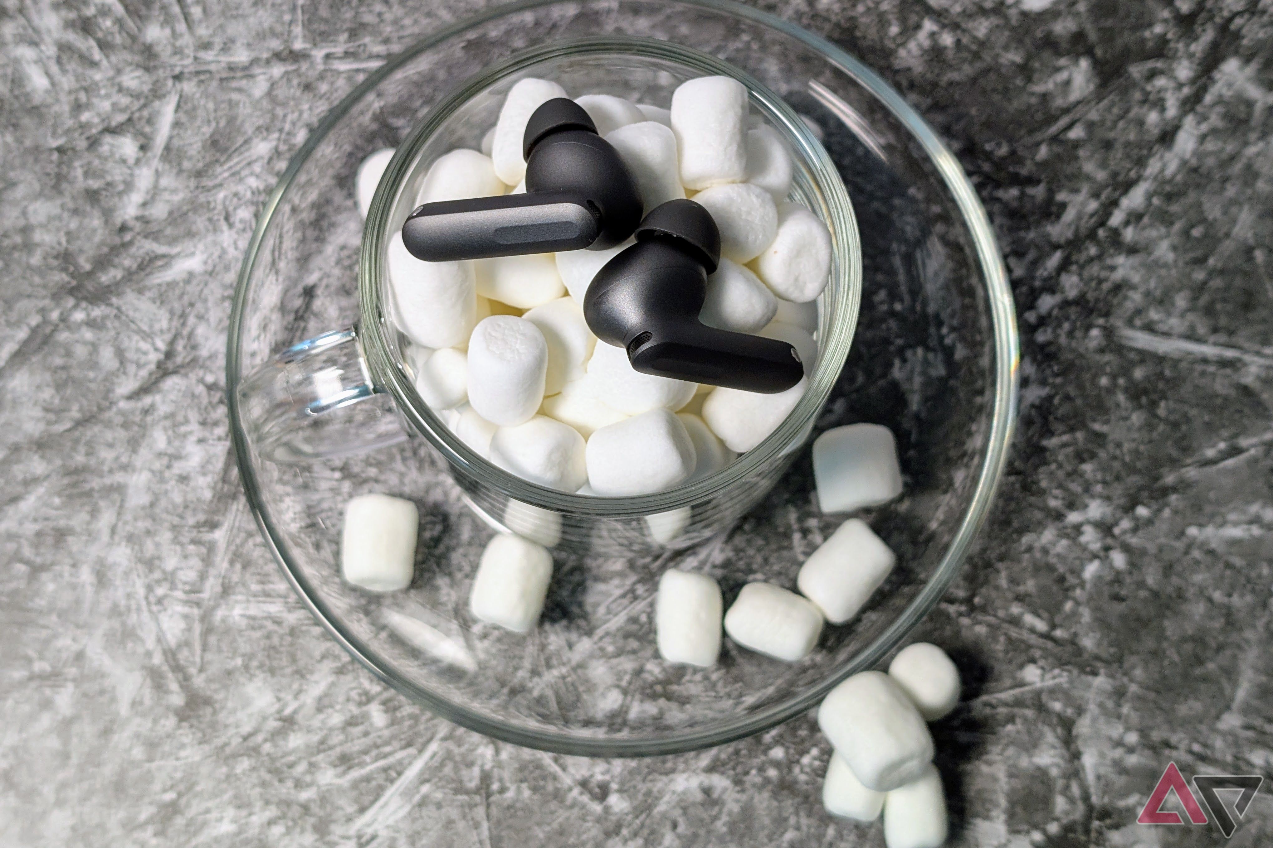 OnePlus Buds 4 in a clear cup with marshmallows