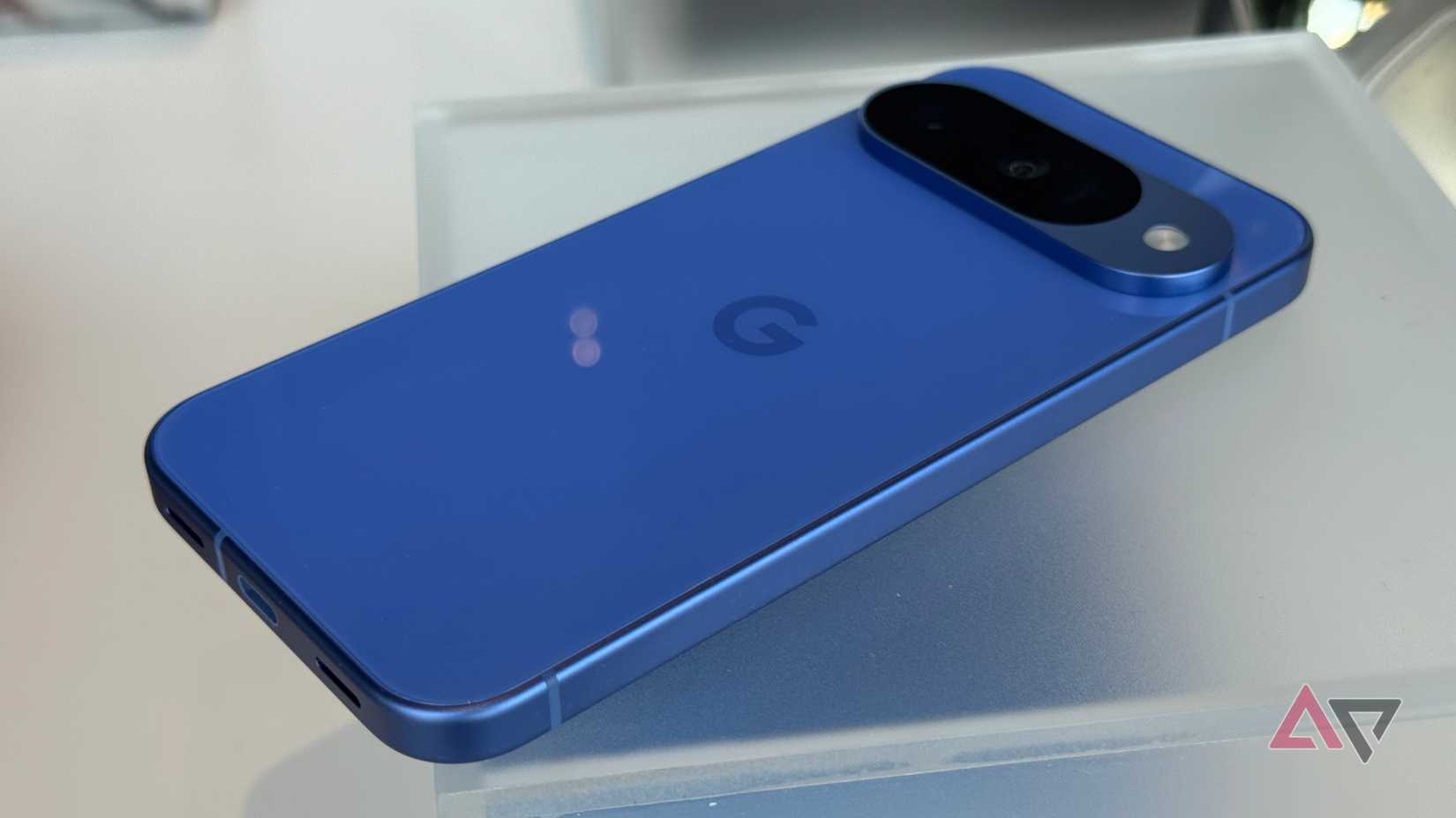 Google Pixel 10 in Indigo laying on glass