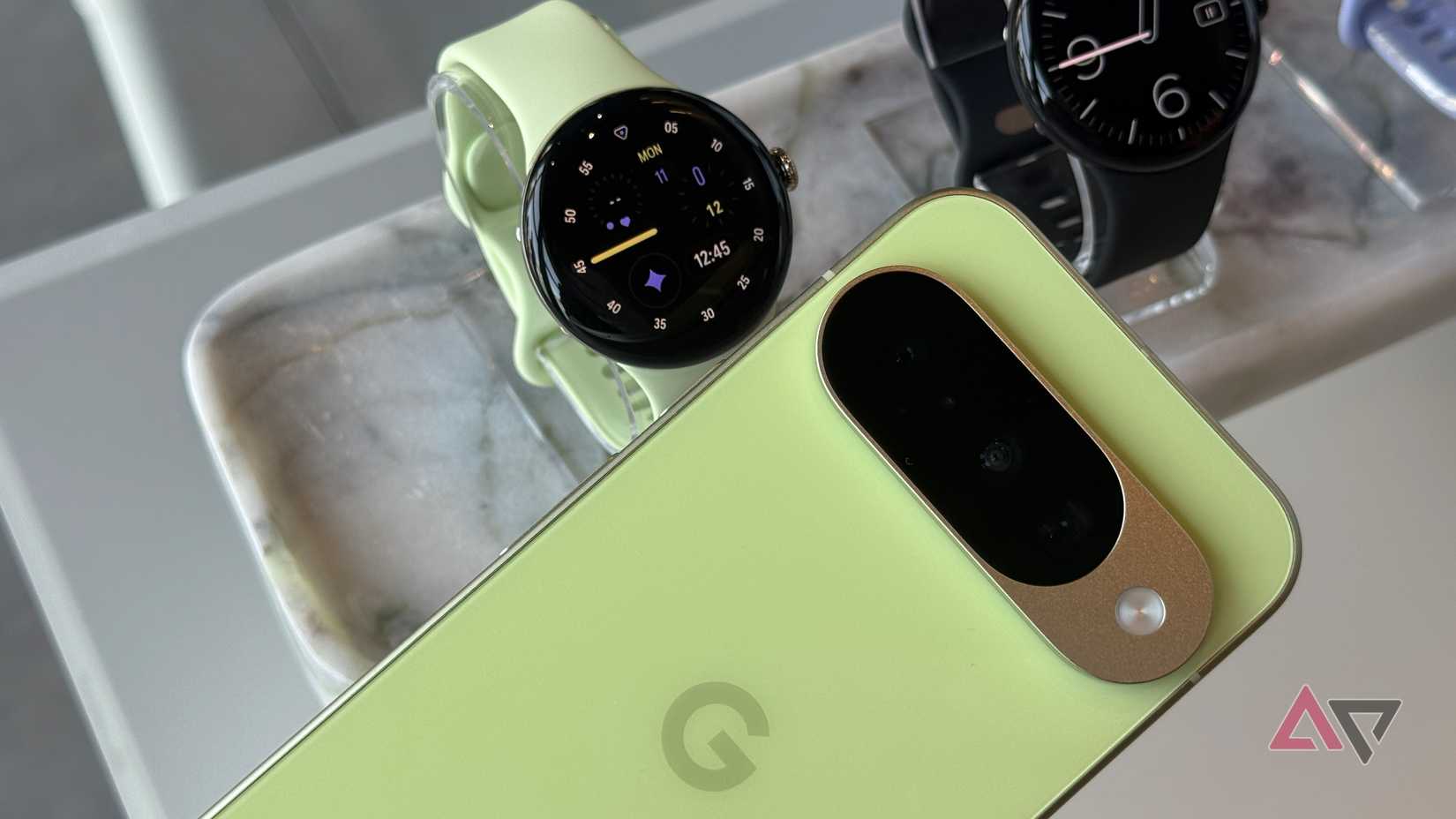 Google Pixel Watch 4 next to the Google Pixel 10