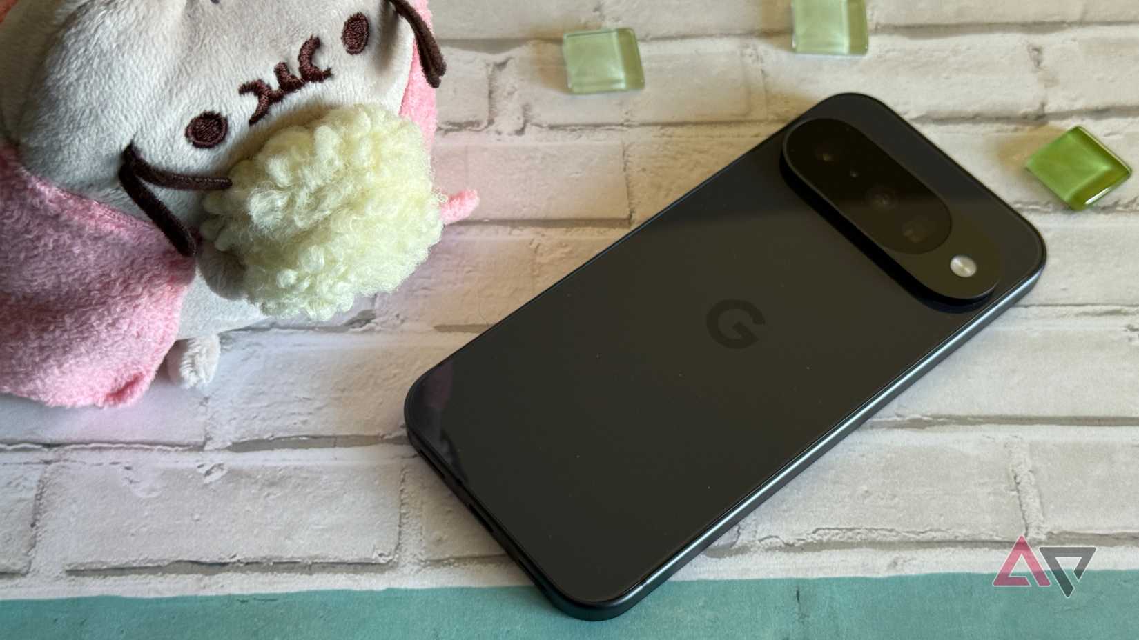 Google Pixel 10 laying next to a Pusheen
