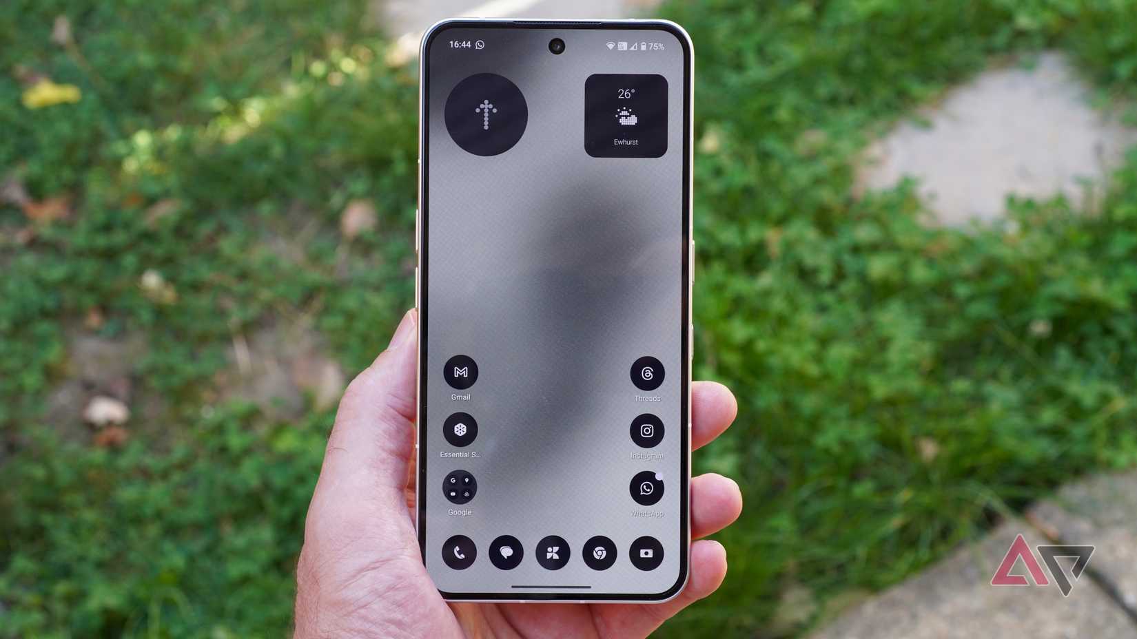 A person holding the Nothing Phone 3, with the Nothing OS 3.5 theme applied to the software